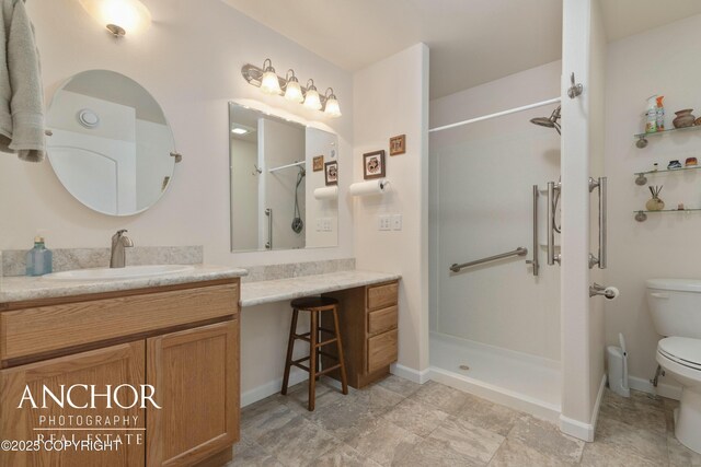 bathroom with baseboards, toilet, a walk in shower, and vanity