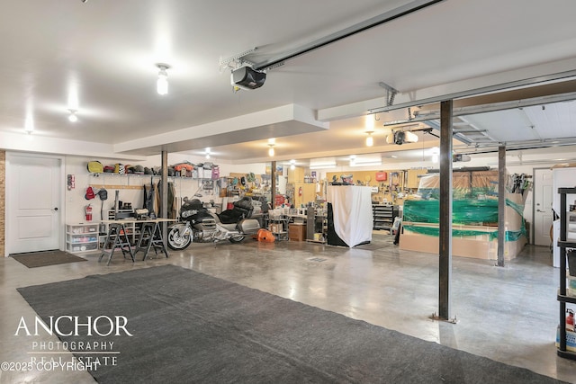 garage featuring a workshop area and a garage door opener