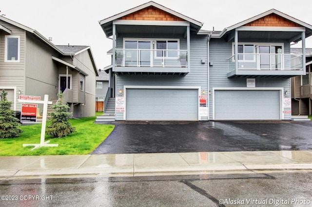 300 Shageluk St, Anchorage, AK 99504 - townhome / multi-family property featuring a front yard, driveway, and a garage