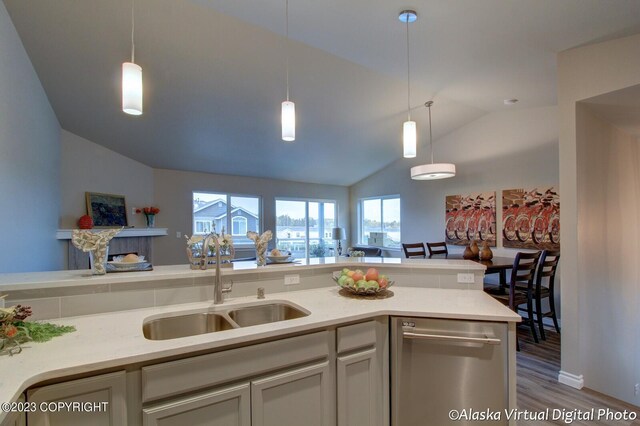 300 Shageluk St, Anchorage, AK 99504 - kitchen featuring decorative light fixtures, vaulted ceiling, a sink, dishwasher, and wood finished floors