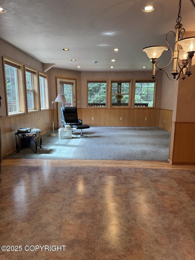 32945 Melanie Ln, Seward, AK 99664 - sitting room featuring plenty of natural light, wooden walls, a wainscoted wall, recessed lighting, and a chandelier