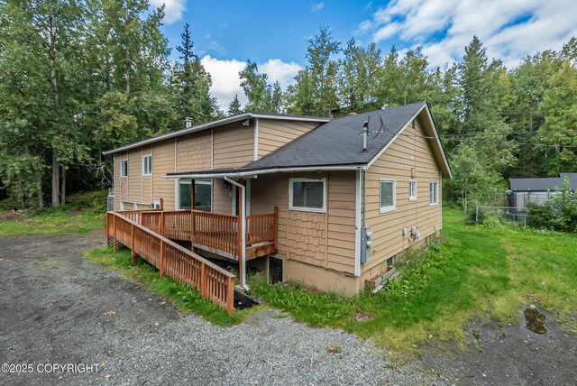 7621 E 4th Ave, Anchorage, AK 99504 - exterior space featuring a yard, roof with shingles, fence, and a deck