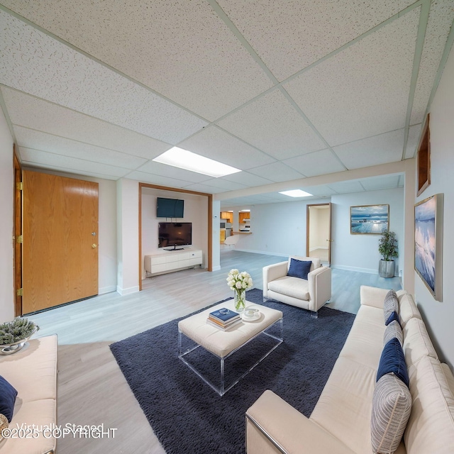 7621 E 4th Ave, Anchorage, AK 99504 - living area with a drop ceiling, baseboards, and wood finished floors