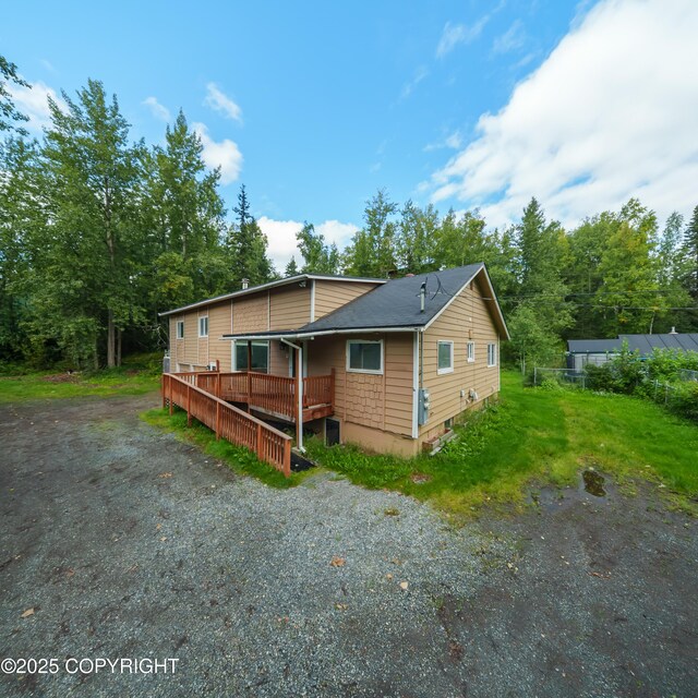 7621 E 4th Ave, Anchorage, AK 99504 - view of front of property with roof with shingles and a wooden deck