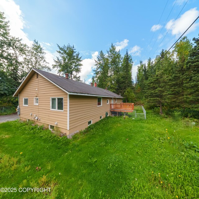 7621 E 4th Ave, Anchorage, AK 99504 - view of side of home with a wooden deck and a yard