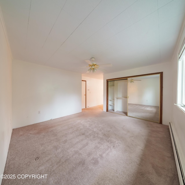 7621 E 4th Ave, Anchorage, AK 99504 - unfurnished bedroom with baseboard heating, ceiling fan, and carpet