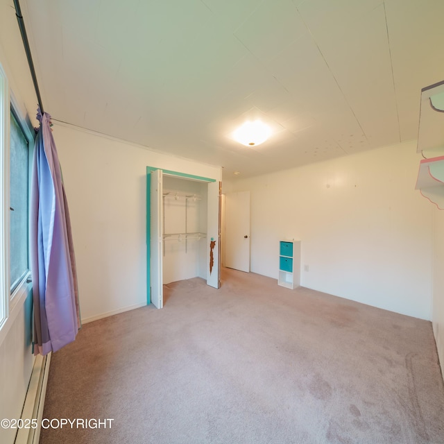7621 E 4th Ave, Anchorage, AK 99504 - unfurnished bedroom featuring a closet, carpet floors, and a baseboard radiator