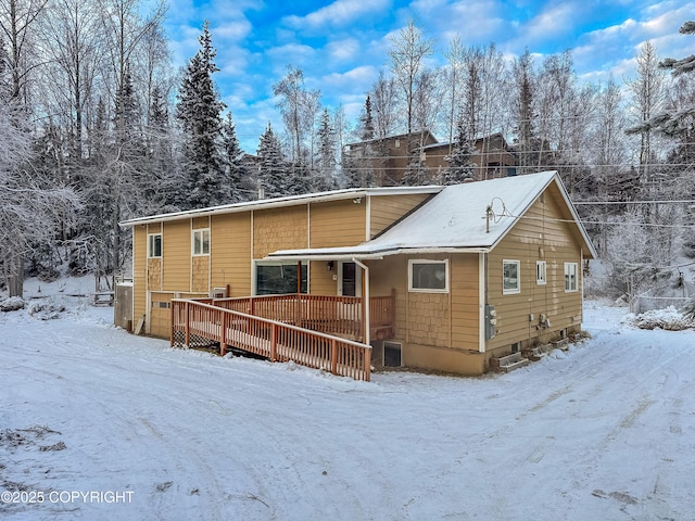 7621 E 4th Ave, Anchorage, AK 99504 - snow covered rear of property with a wooden deck