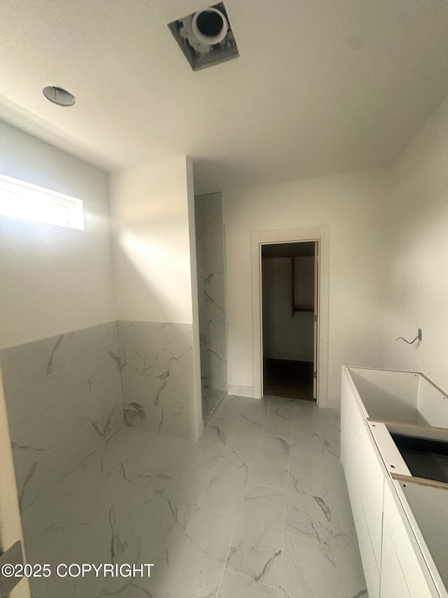 full bath featuring marble finish floor