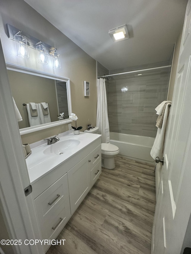 140 Standard Dr, Kenai, AK 99611 - full bathroom with toilet, wood finished floors, vanity, and shower / bath combo with shower curtain