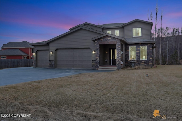 view of front facade featuring a garage, driveway, stone siding, and a front lawn