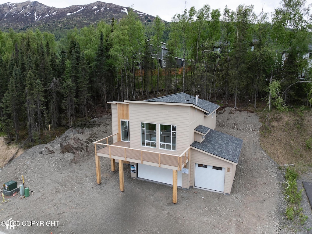18052 Rivervista Rd, Eagle River, AK 99577 - view of front of property with a mountain view, roof with shingles, and dirt driveway