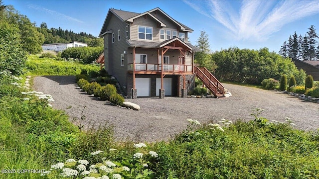 3866 Cabana Ct, Homer, AK 99603 - view of front of home featuring stairs, dirt driveway, an attached garage, and covered porch