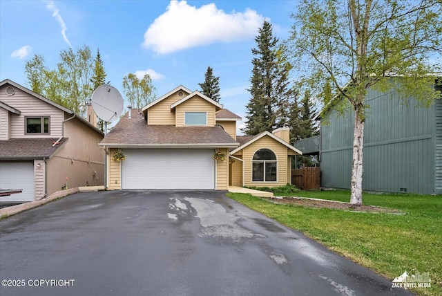 view of front of property with asphalt driveway, a shingled roof, and a garage