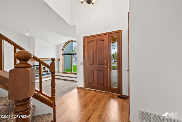 entryway with wood finished floors and stairs