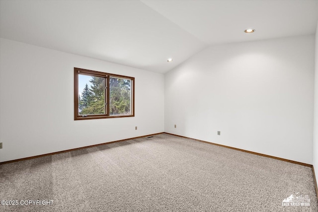 empty room with lofted ceiling, carpet flooring, baseboards, and recessed lighting
