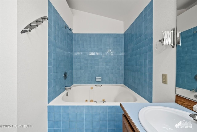 full bath featuring vanity and a combined bath / shower with jetted tub