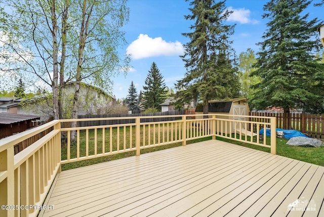 deck featuring a shed and an outdoor structure