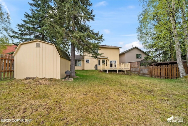 rear view of house featuring a storage shed and an outbuilding