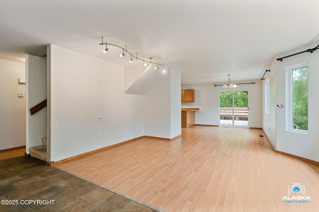 19306 Second St, Eagle River, AK 99577 - unfurnished living room with baseboards, stairs, and wood finished floors
