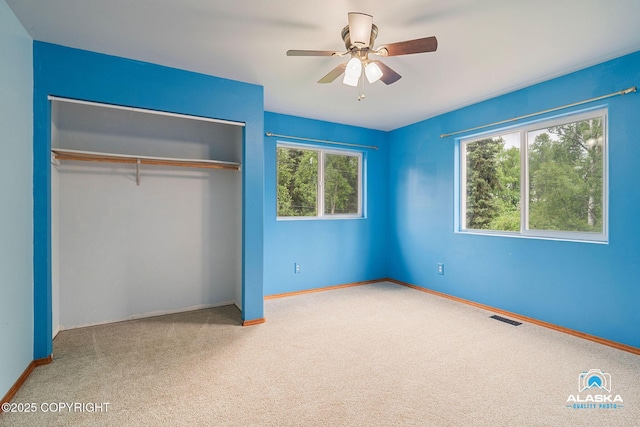 19306 Second St, Eagle River, AK 99577 - unfurnished bedroom featuring carpet, a closet, baseboards, and ceiling fan