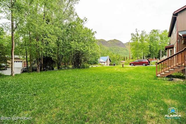 19306 Second St, Eagle River, AK 99577 - view of green lawn featuring a mountain view and stairway