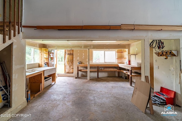 19306 Second St, Eagle River, AK 99577 - miscellaneous room featuring a workshop area and unfinished concrete floors