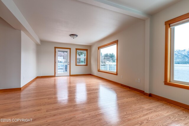 5751 N Tongass Hwy, Ketchikan, AK 99901 - unfurnished room featuring light wood finished floors, baseboards, and a healthy amount of sunlight