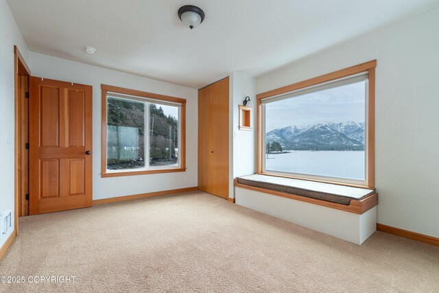 5751 N Tongass Hwy, Ketchikan, AK 99901 - empty room with baseboards, carpet, and plenty of natural light