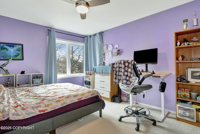 carpeted bedroom with a ceiling fan and baseboards