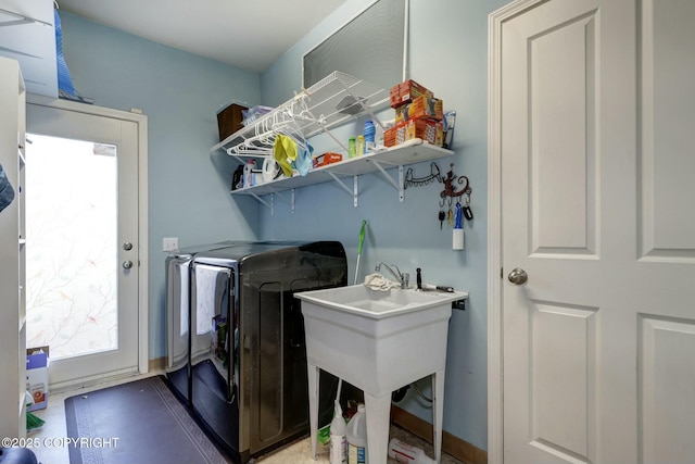 laundry area featuring washing machine and clothes dryer and laundry area