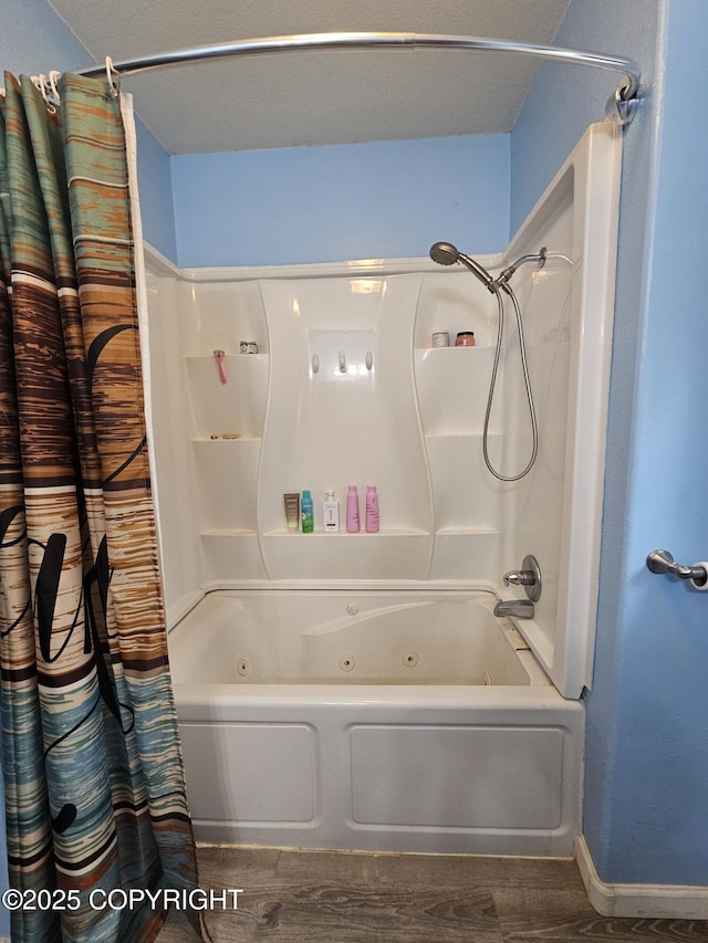 full bathroom with a combined bath / shower with jetted tub, baseboards, and wood finished floors