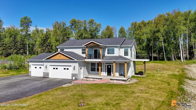 8007 S Knik Knack Mud Shack Rd, Wasilla, AK 99623 - view of front of home featuring a balcony, a garage, covered porch, a front lawn, and driveway