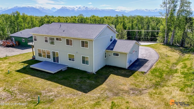 8007 S Knik Knack Mud Shack Rd, Wasilla, AK 99623 - back of house featuring roof with shingles, a yard, a deck with mountain view, and a view of trees