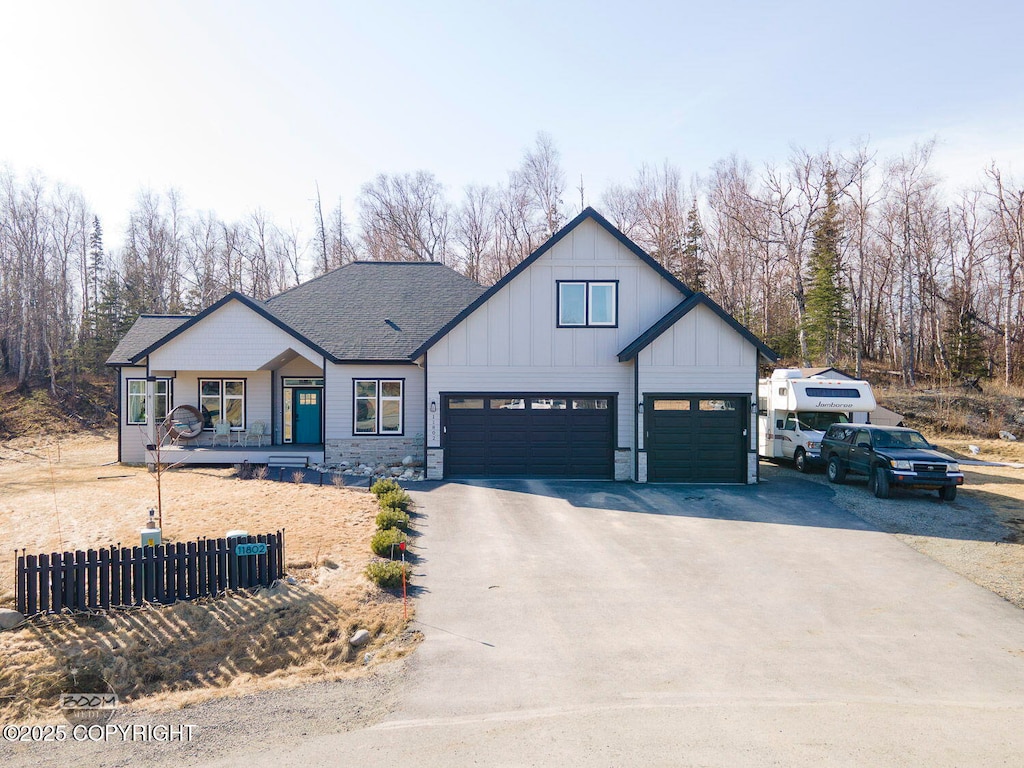 11802 E Pella Cir, Palmer, AK 99645 - view of front of house with concrete driveway, roof with shingles, fence, board and batten siding, and a garage