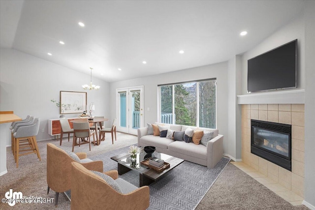 carpeted living room with a tiled fireplace, vaulted ceiling, recessed lighting, and a notable chandelier