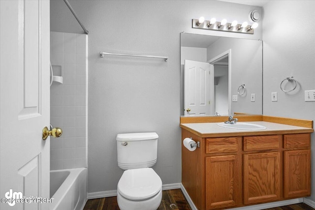 full bathroom featuring vanity, tub / shower combination, wood finished floors, and toilet