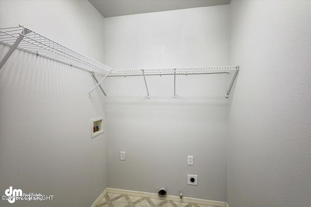 laundry area featuring laundry area, baseboards, electric dryer hookup, washer hookup, and hookup for a gas dryer