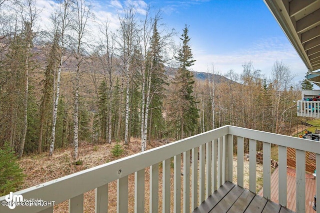 wooden terrace with a view of trees
