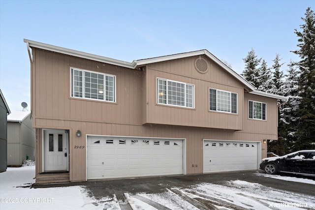 view of front of home with an attached garage and aphalt driveway
