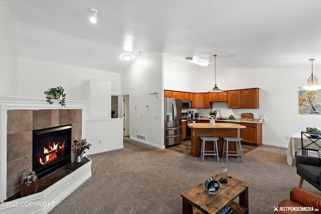 living room with a fireplace, visible vents, baseboards, and carpet floors