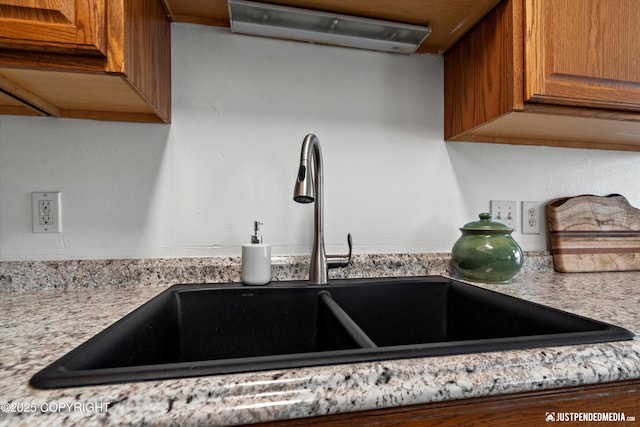details with brown cabinets and a sink