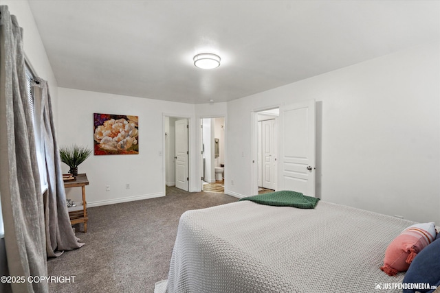 bedroom featuring ensuite bath, baseboards, and carpet floors