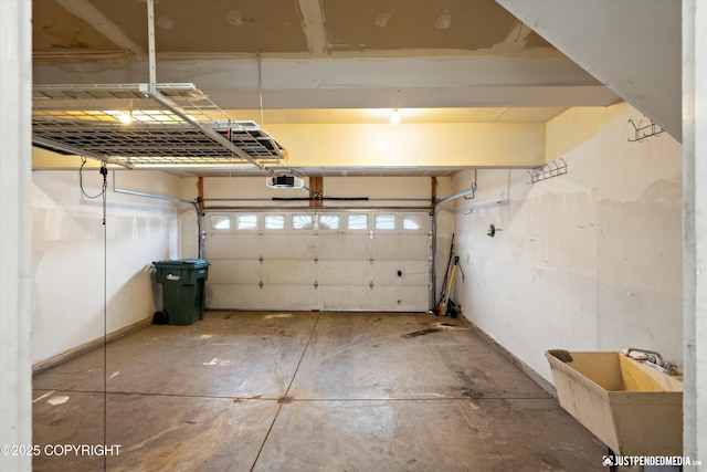 garage with a sink and a garage door opener