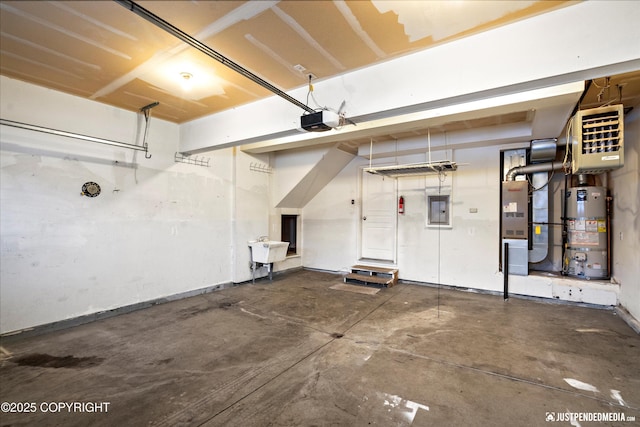 garage featuring electric panel, a sink, heating unit, gas water heater, and a garage door opener