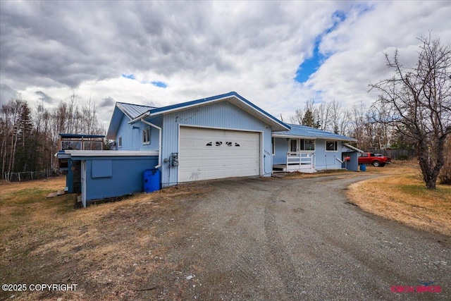 16500 E Smith Rd, Palmer, AK 99645 - view of front facade with an attached garage, driveway, and metal roof