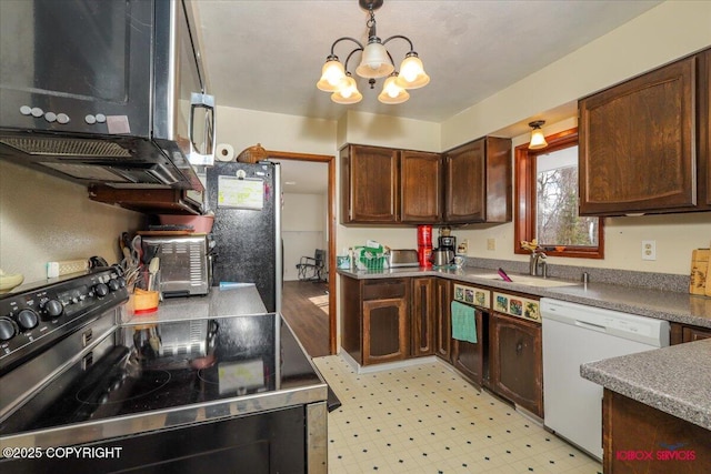 16500 E Smith Rd, Palmer, AK 99645 - kitchen featuring pendant lighting, appliances with stainless steel finishes, a sink, a notable chandelier, and light floors