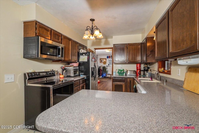 16500 E Smith Rd, Palmer, AK 99645 - kitchen featuring pendant lighting, a peninsula, a chandelier, a sink, and stainless steel appliances
