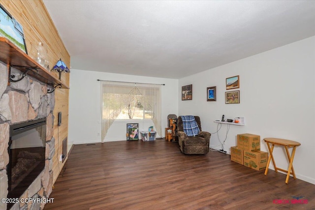 16500 E Smith Rd, Palmer, AK 99645 - sitting room featuring a stone fireplace and wood finished floors