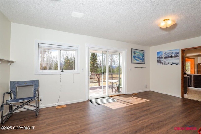 16500 E Smith Rd, Palmer, AK 99645 - unfurnished room featuring baseboards, a textured ceiling, visible vents, and wood finished floors